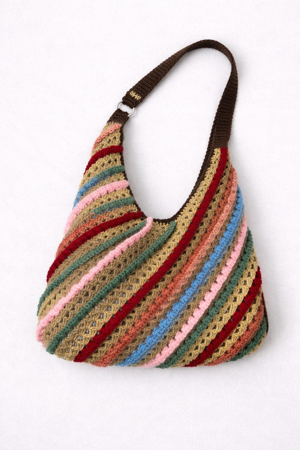 Multicolored striped handbag with a brown handle on a white background