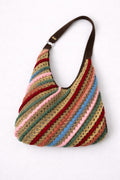Multicolored striped handbag with a brown handle on a white background