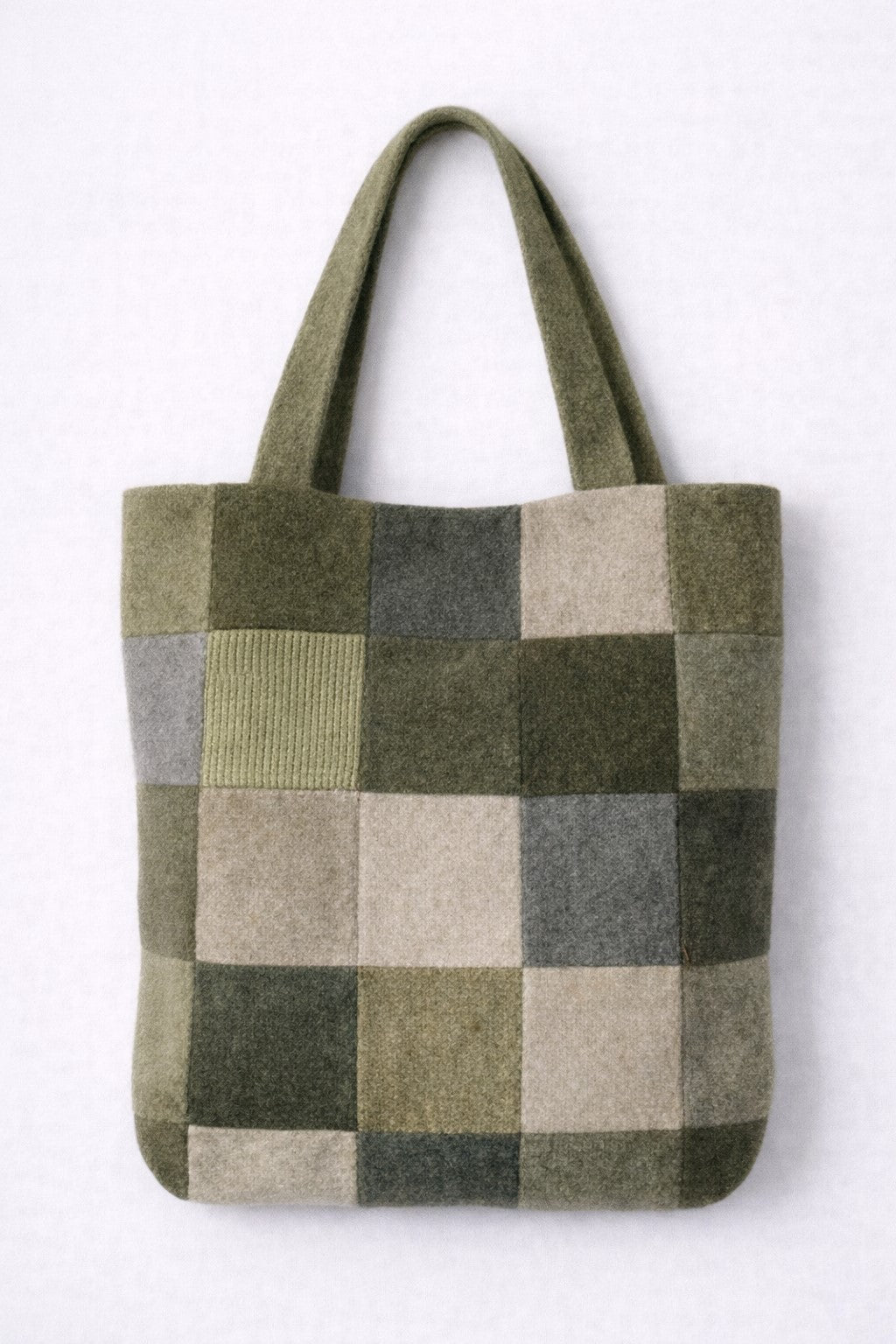 Checkered tote bag with green, gray, and beige pattern on a white background